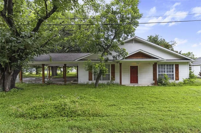a front view of a house with a garden