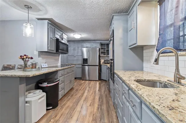 a kitchen with a sink stove and refrigerator