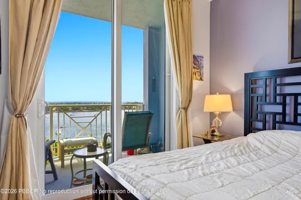 a bedroom with a bed and large window