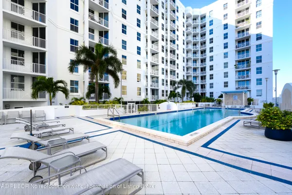 a view of a swimming pool with outdoor seating