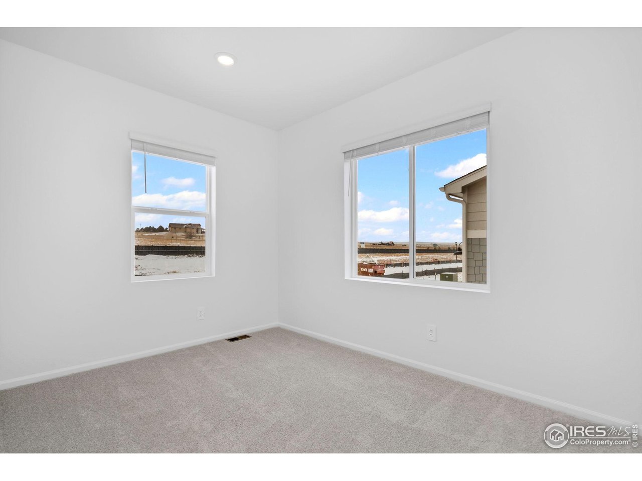 7339 27th St Lane Greeley, CO 80634 - Photo 11 of 32 a view of an empty room with a window