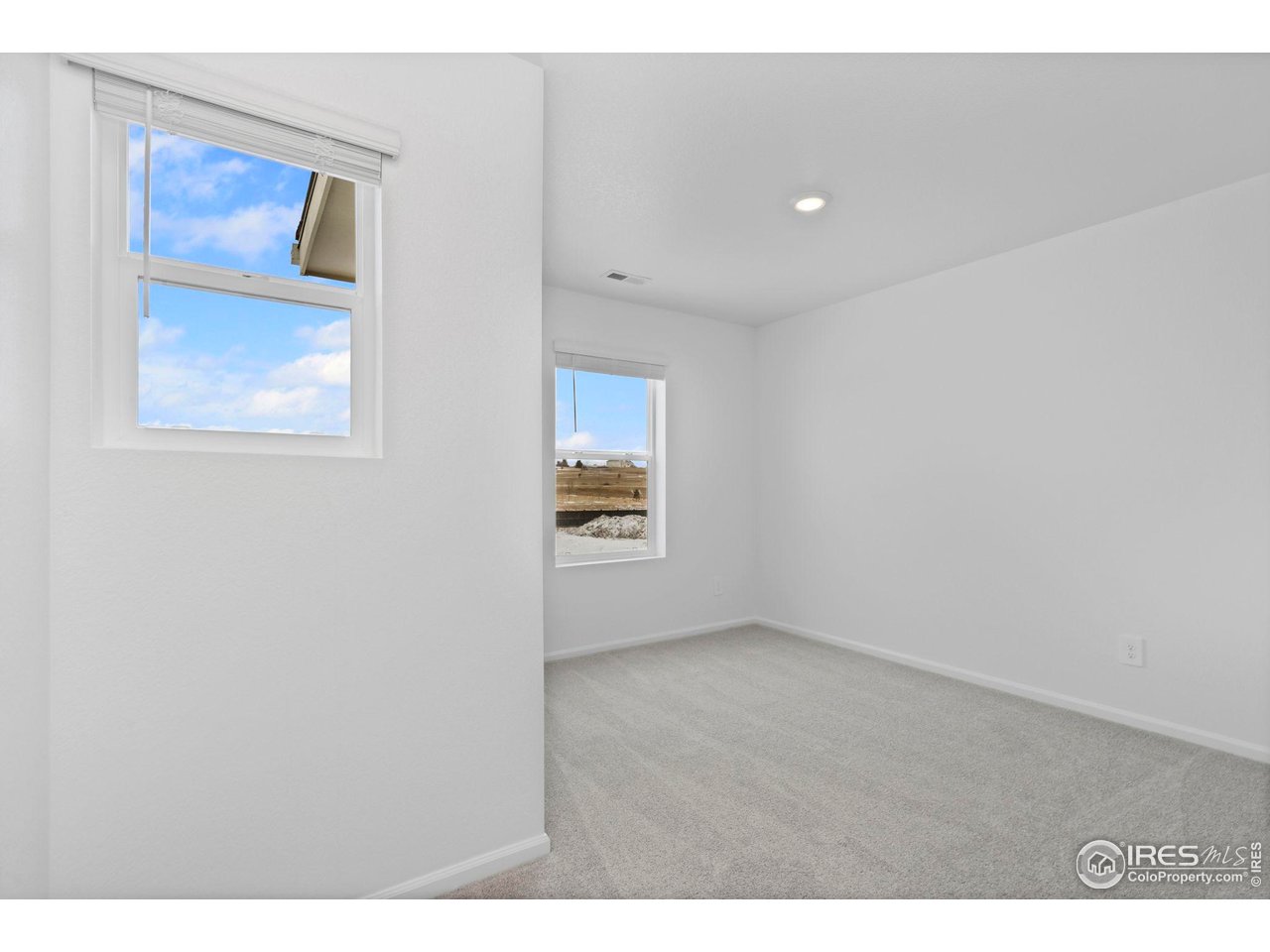 7339 27th St Lane Greeley, CO 80634 - Photo 18 of 32 a view of an empty room with a window