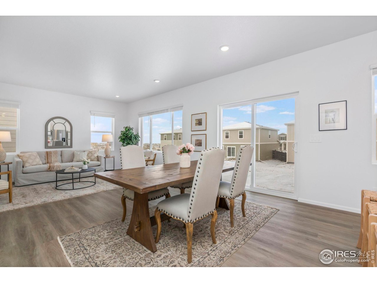 7339 27th St Lane Greeley, CO 80634 - Photo 6 of 32 a view of a dining room with furniture and wooden floor