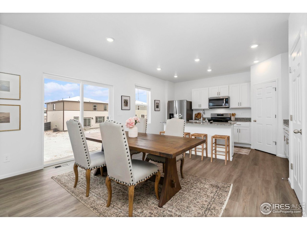 7339 27th St Lane Greeley, CO 80634 - Photo 8 of 32 a view of a dining room with furniture and wooden floor