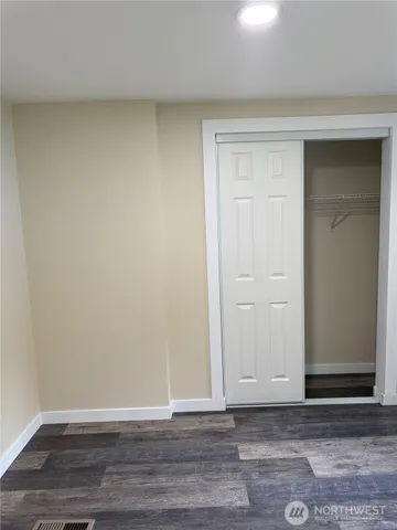 a view of an empty room and wooden floor