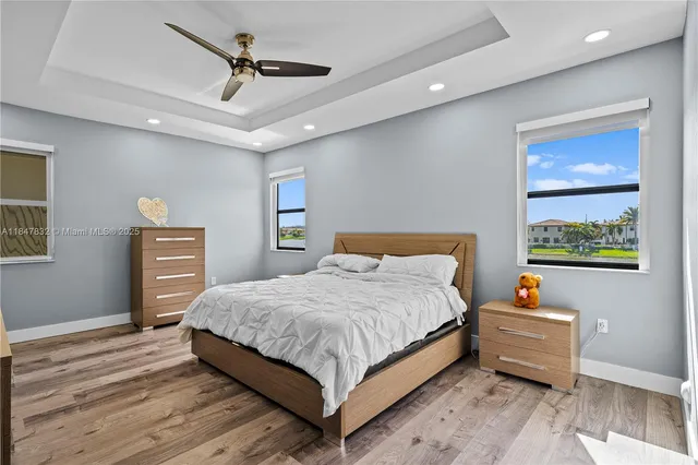 a bathroom with a sink double vanity granite tub and a mirror