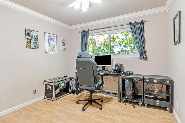 a view of a workspace with furniture and a window