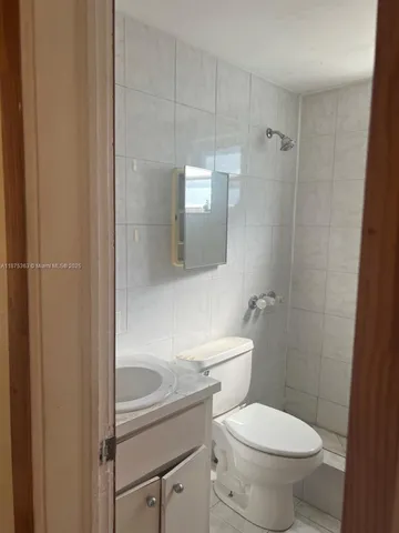 an empty room with wooden floor and closet