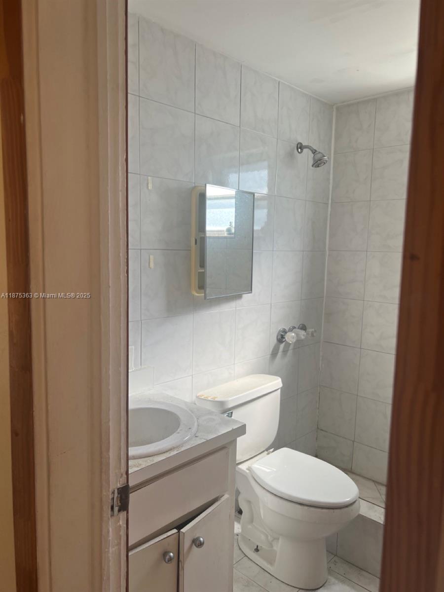 470 Northeast 130th Street North Miami, FL 33161 - Photo 15 of 21 a white toilet sitting next to a bathroom sink