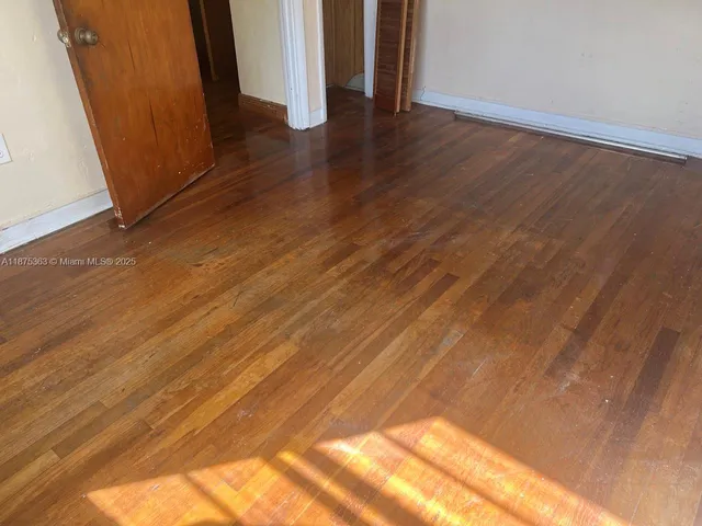 a view of a house with a yard and large trees