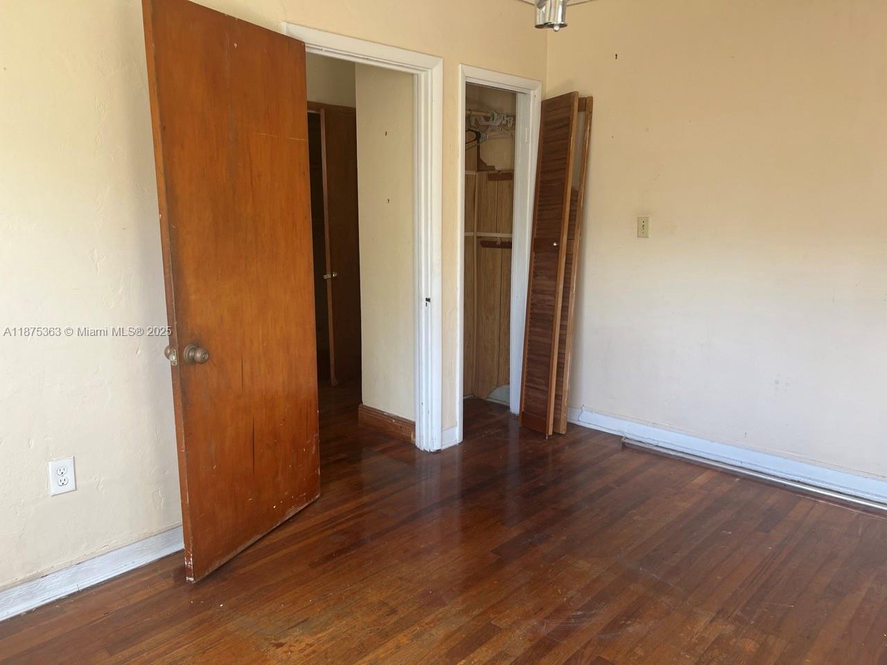 470 Northeast 130th Street North Miami, FL 33161 - Photo 18 of 21 an empty room with wooden floor and closet