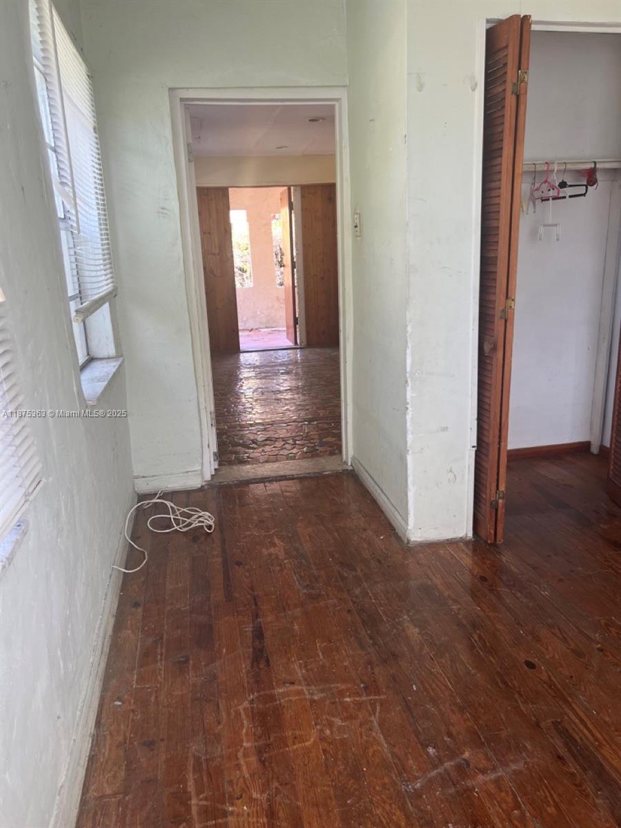 470 Northeast 130th Street North Miami, FL 33161 - Photo 8 of 21 a view of a hallway with wooden floor and a bathroom