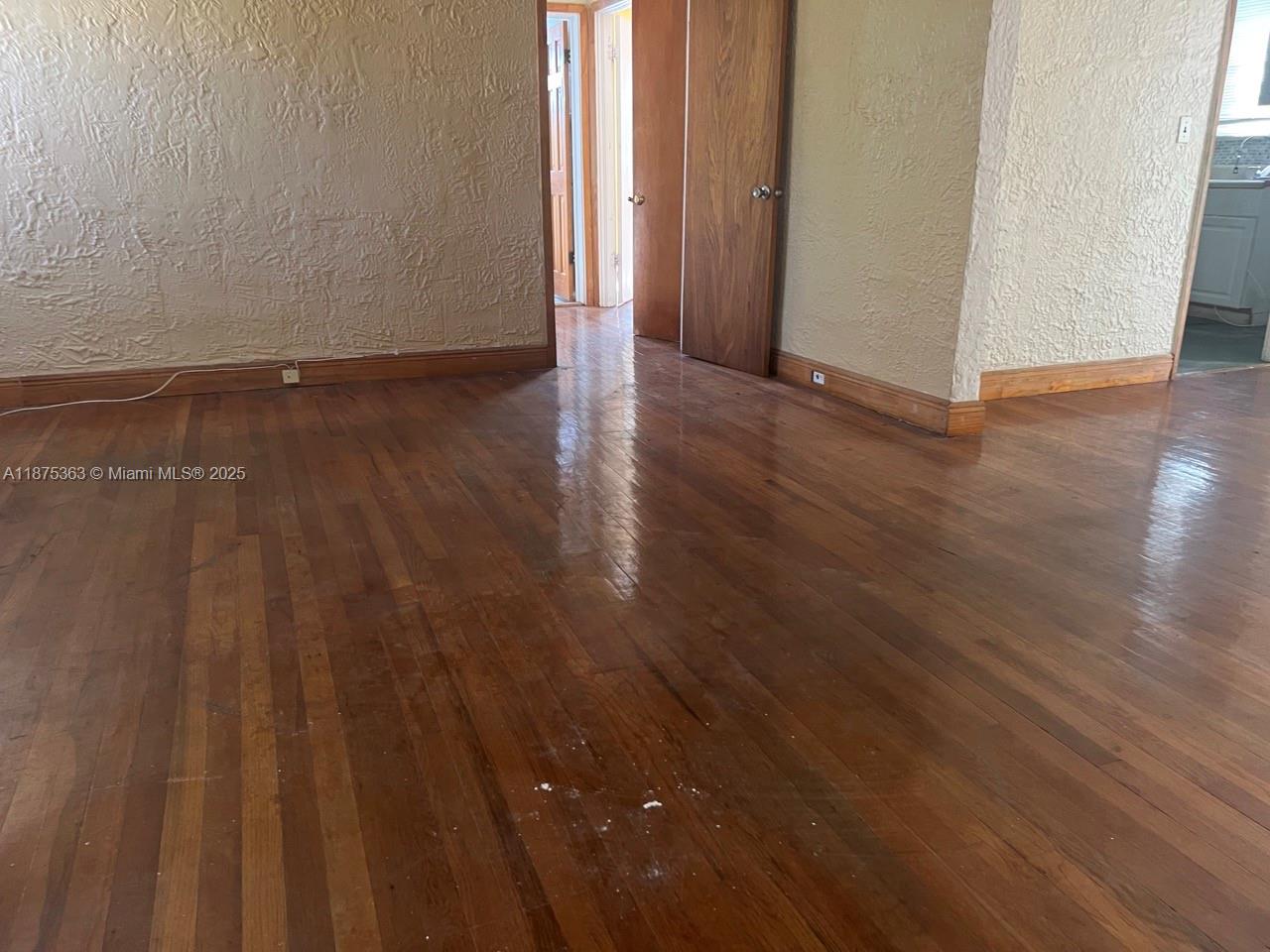 470 Northeast 130th Street North Miami, FL 33161 - Photo 9 of 21 a view of an empty room and wooden floor