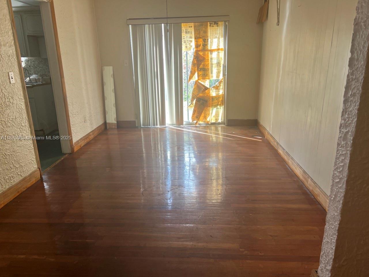 470 Northeast 130th Street North Miami, FL 33161 - Photo 10 of 21 a view of an empty room with wooden floor and a window