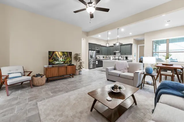a living room with furniture and a chandelier