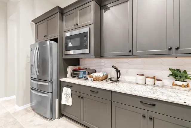 a kitchen with stainless steel appliances granite countertop a refrigerator and a sink