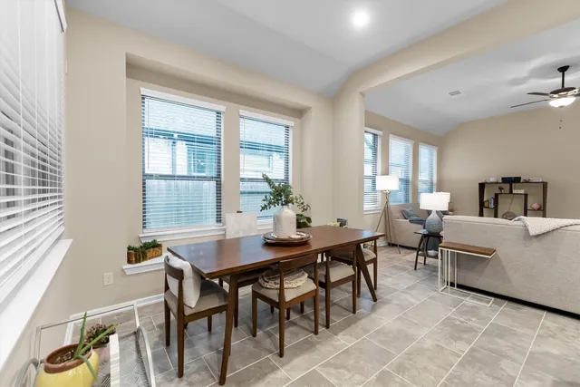 a dining room with furniture and window