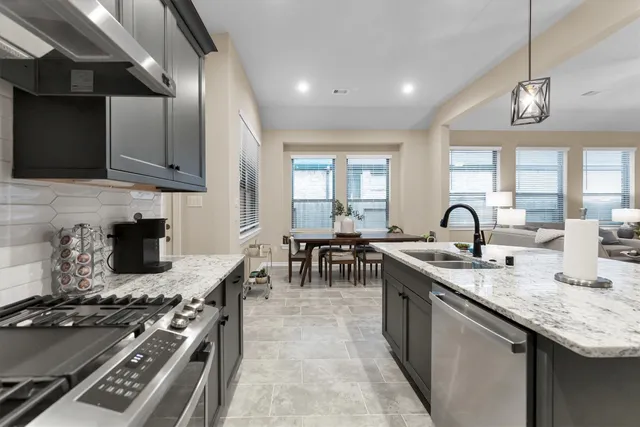 a kitchen with sink stove and cabinets