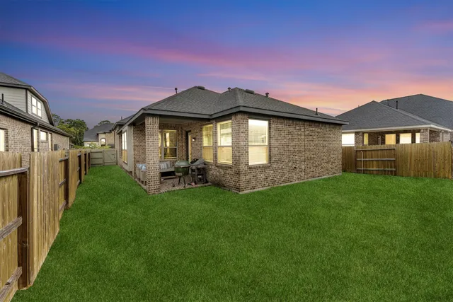 a backyard of a house with table and chairs