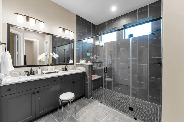 a bathroom with a shower sink and mirror