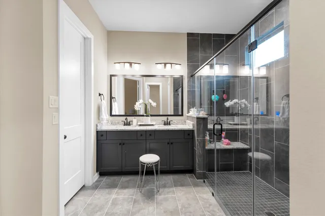 a room with granite countertop lots of wooden furniture and a chandelier