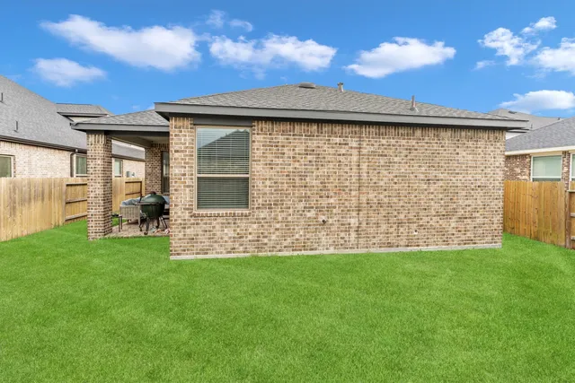 a view of house with backyard