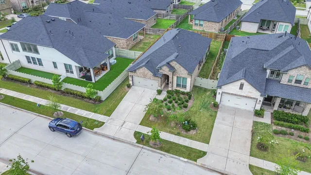 an aerial view of multiple houses with a yard