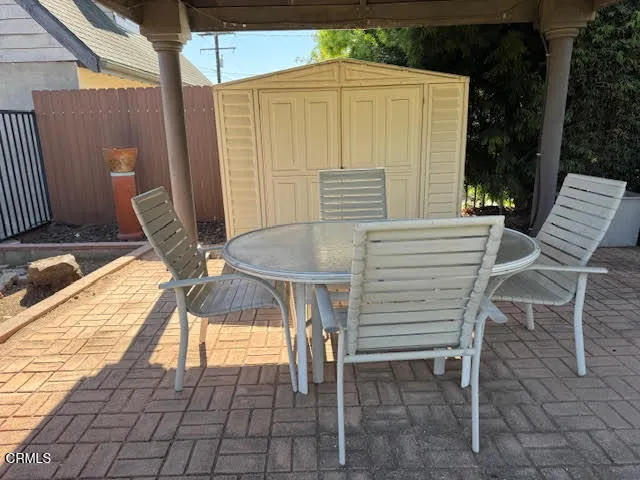 a view of a patio with a table and chairs