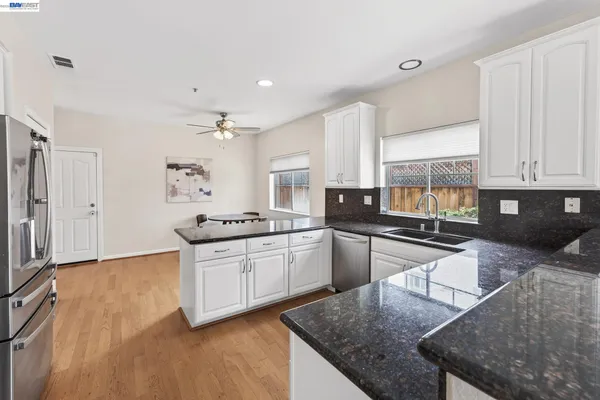 a bedroom with a bed and a chandelier fan