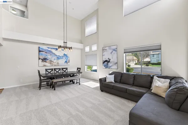 a kitchen with granite countertop stainless steel appliances a refrigerator and a stove top oven