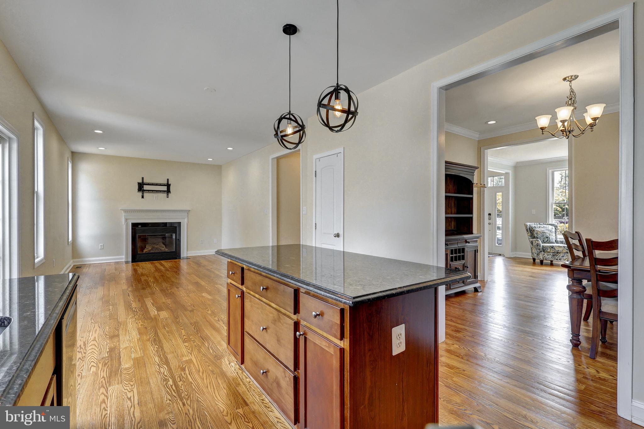 412 Shipley Road Linthicum Heights, MD 21090 - Photo 9 of 36 Kitchen island w/ pendant lights and famrm w/fpl