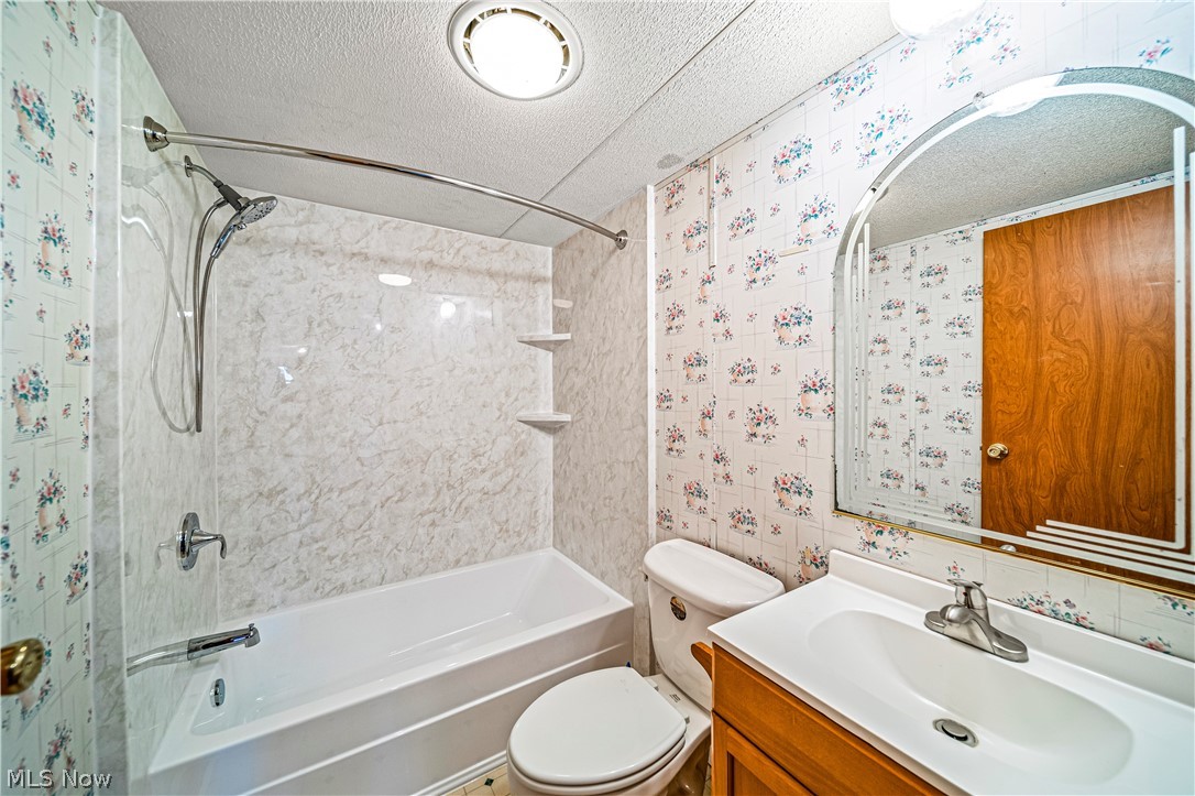 3471 Fox Road Kingsville, OH 44048 - Photo 33 of 50 Full bathroom with shower combination, toilet, a textured ceiling, and vanity