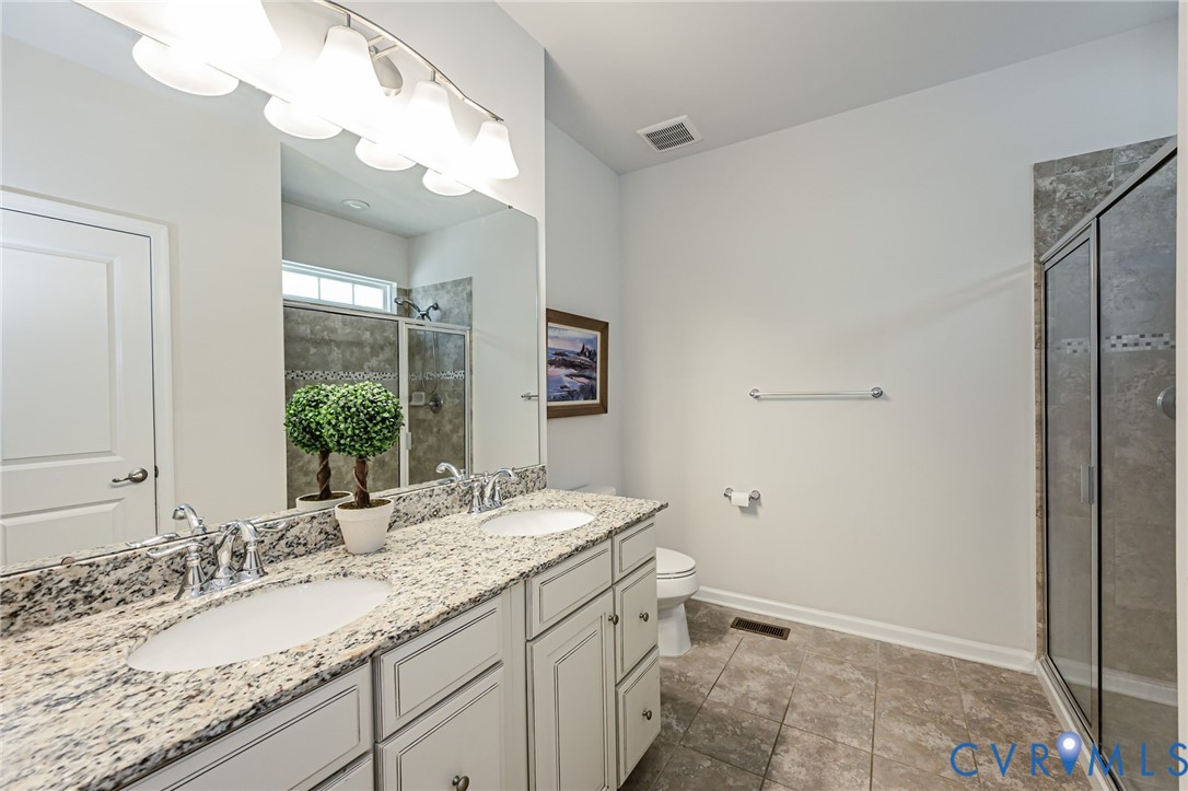 7435 Wicks Road Williamsburg, VA 23188 - Photo 47 of 82 Primary Bathroom featuring a double vanity with st