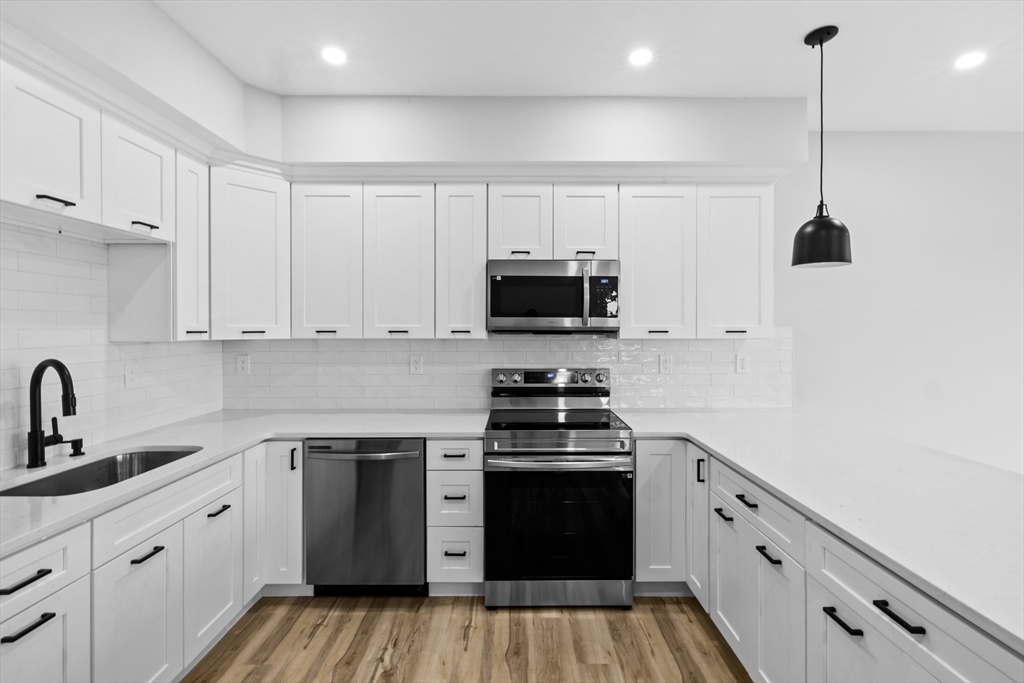 889-895 Grinnell Street, Unit 2 Fall River, MA 02721 - Photo 13 of 42 a kitchen with appliances a sink and cabinets