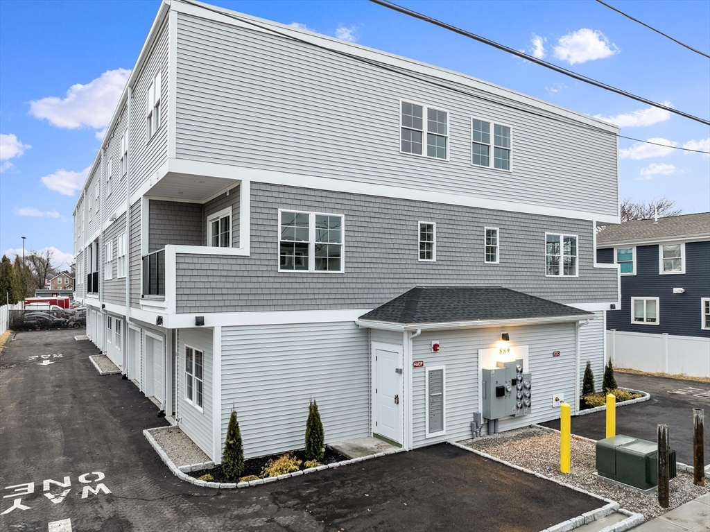 889-895 Grinnell Street, Unit 2 Fall River, MA 02721 - Photo 2 of 42 a front view of a house with a yard