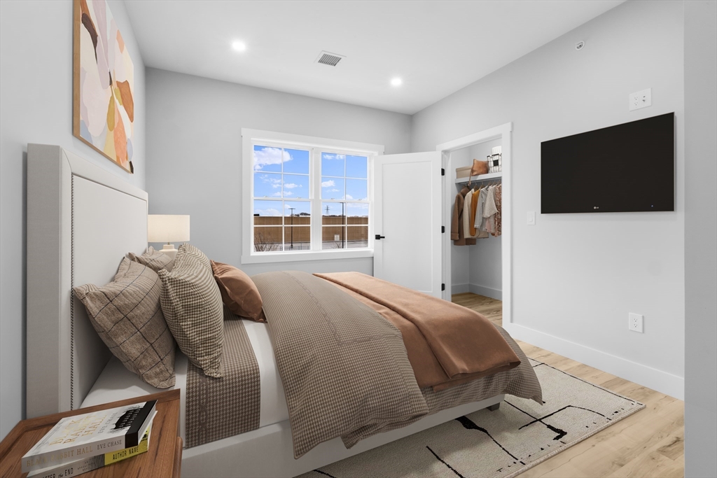 889-895 Grinnell Street, Unit 2 Fall River, MA 02721 - Photo 26 of 42 a bedroom with a bed and a flat screen tv