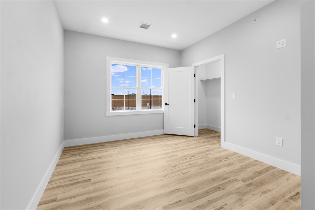 889-895 Grinnell Street, Unit 2 Fall River, MA 02721 - Photo 28 of 42 a view of an empty room with wooden floor and a window