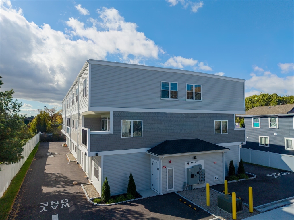 889-895 Grinnell Street, Unit 2 Fall River, MA 02721 - Photo 37 of 42 a front view of a house with a yard