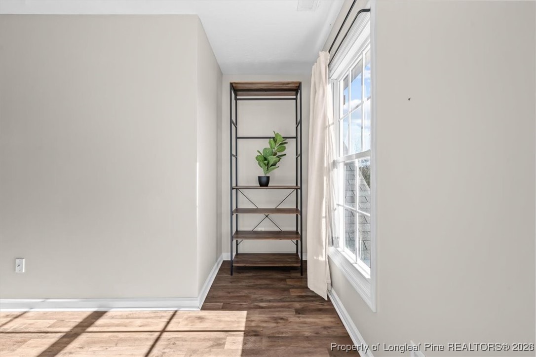 2736 Millmann Road Fayetteville, NC 28304 - Photo 21 of 33 a view of a hallway with wooden floor and a dining room