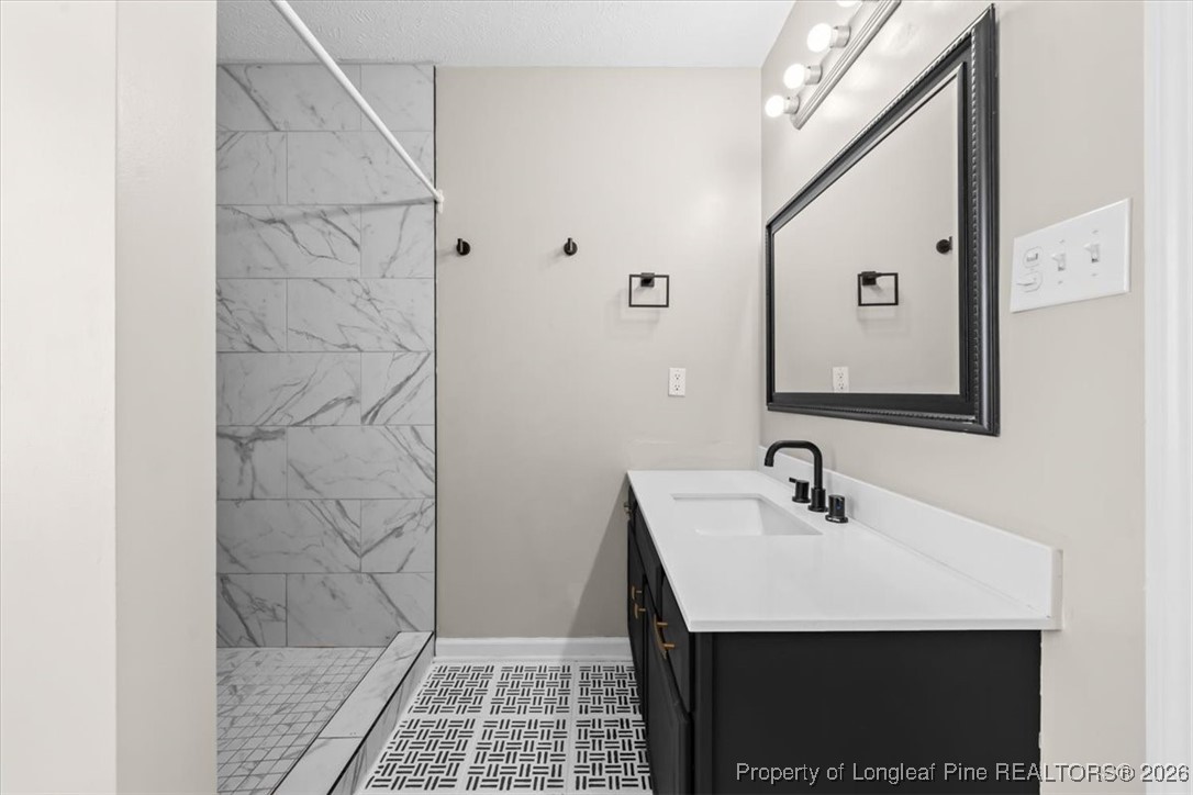 2736 Millmann Road Fayetteville, NC 28304 - Photo 23 of 33 a bathroom with a sink and a mirror