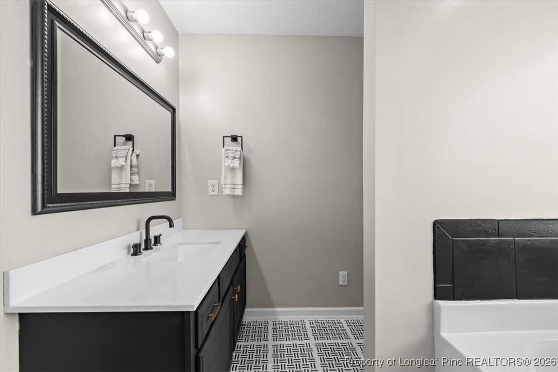 2736 Millmann Road Fayetteville, NC 28304 - Photo 25 of 33 a bathroom with a sink and a mirror