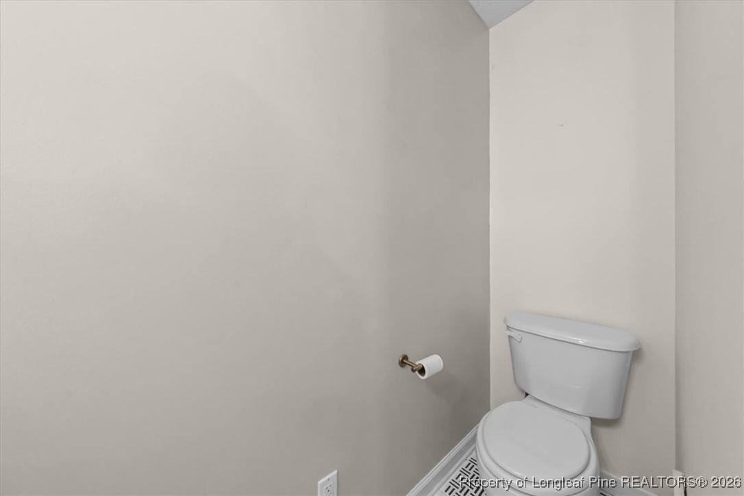 2736 Millmann Road Fayetteville, NC 28304 - Photo 29 of 33 a white toilet sitting next to a white wall