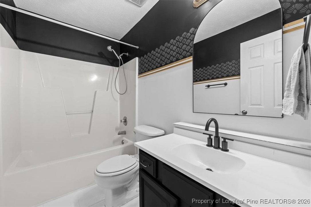 2736 Millmann Road Fayetteville, NC 28304 - Photo 30 of 33 a bathroom with a sink a toilet and shower
