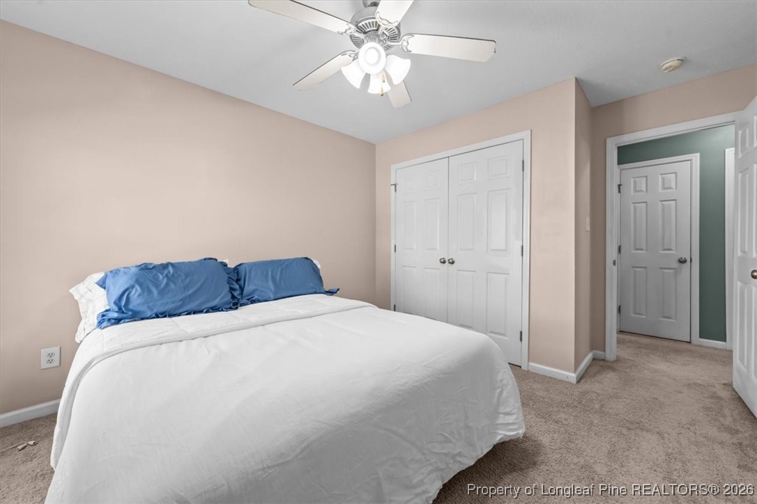 2736 Millmann Road Fayetteville, NC 28304 - Photo 31 of 33 a bedroom with a bed and a chandelier