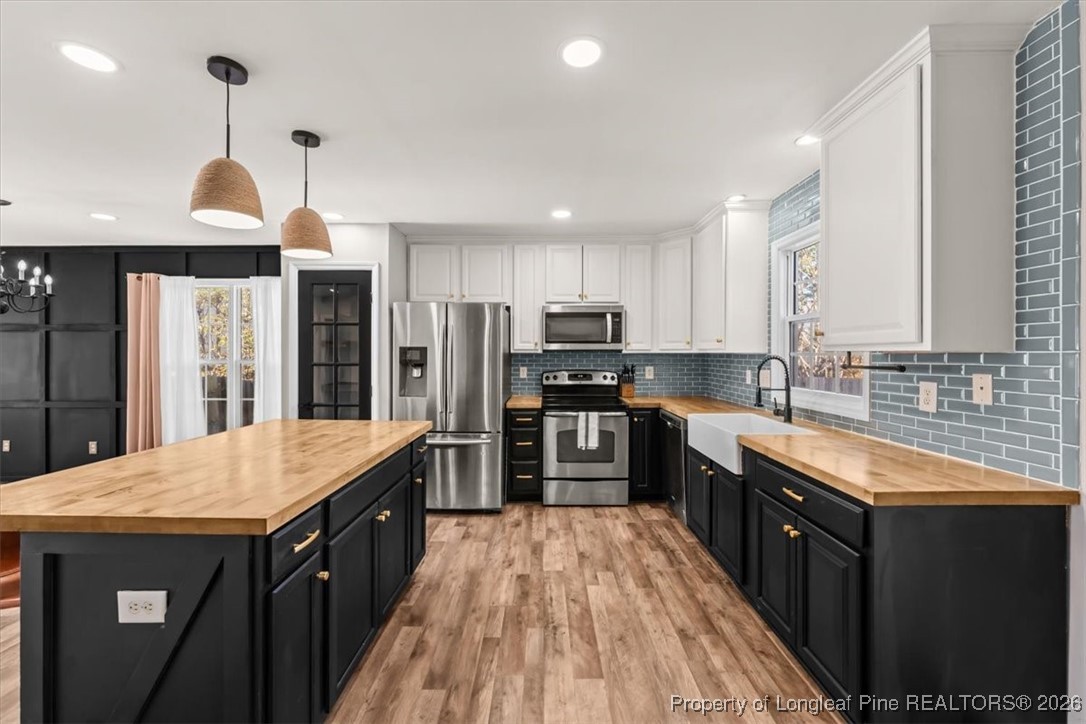 2736 Millmann Road Fayetteville, NC 28304 - Photo 10 of 33 a kitchen with stainless steel appliances granite countertop a refrigerator a sink dishwasher a stove and white countertops with wooden floor