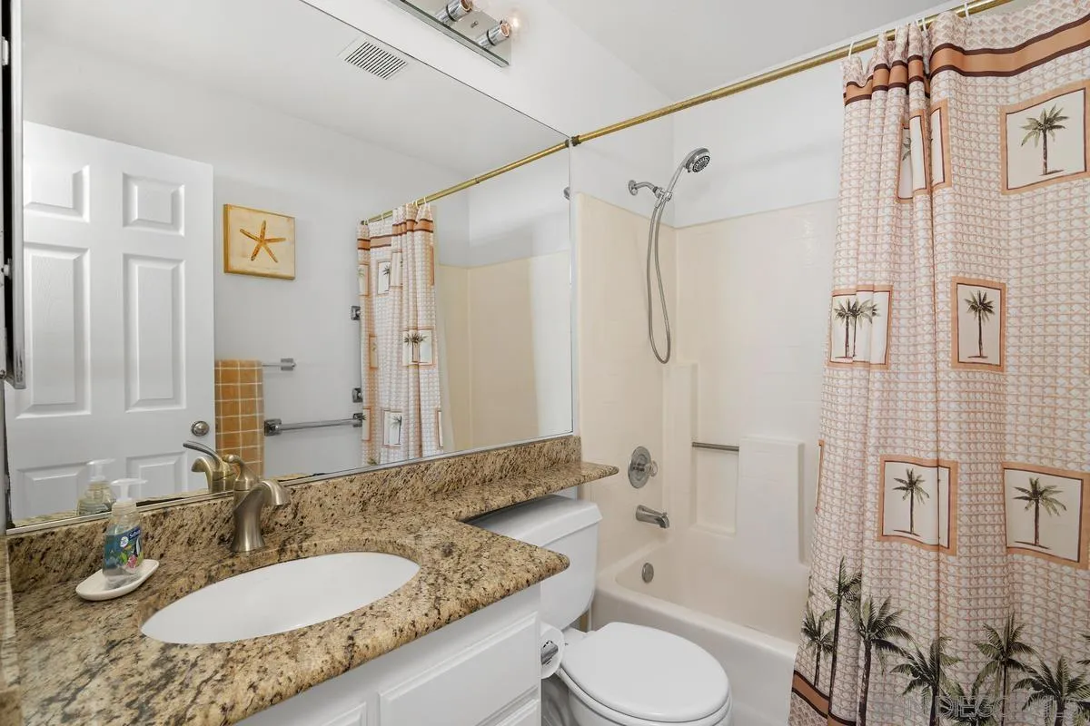 649 Montage Road Oceanside, CA 92057 - Photo 12 of 26 a bathroom with a granite countertop sink toilet a shower and a mirror