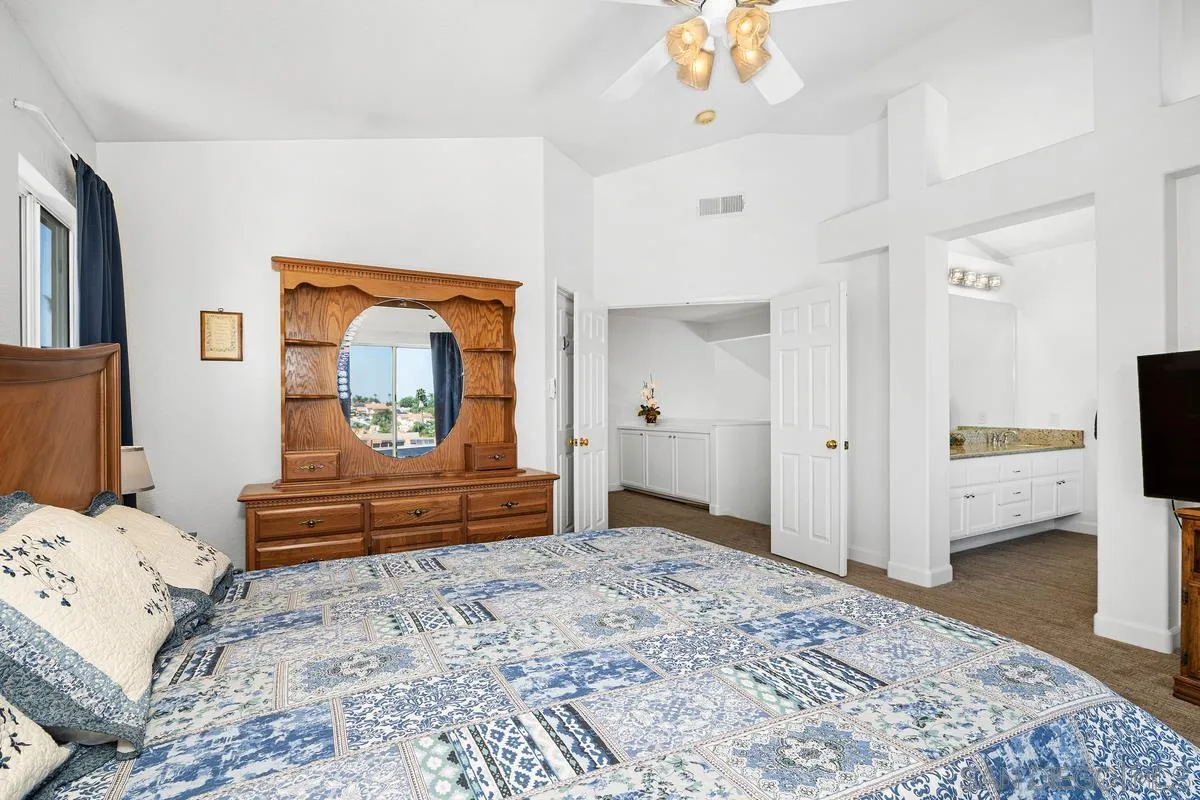 649 Montage Road Oceanside, CA 92057 - Photo 14 of 26 a bedroom with a bed and a chandelier