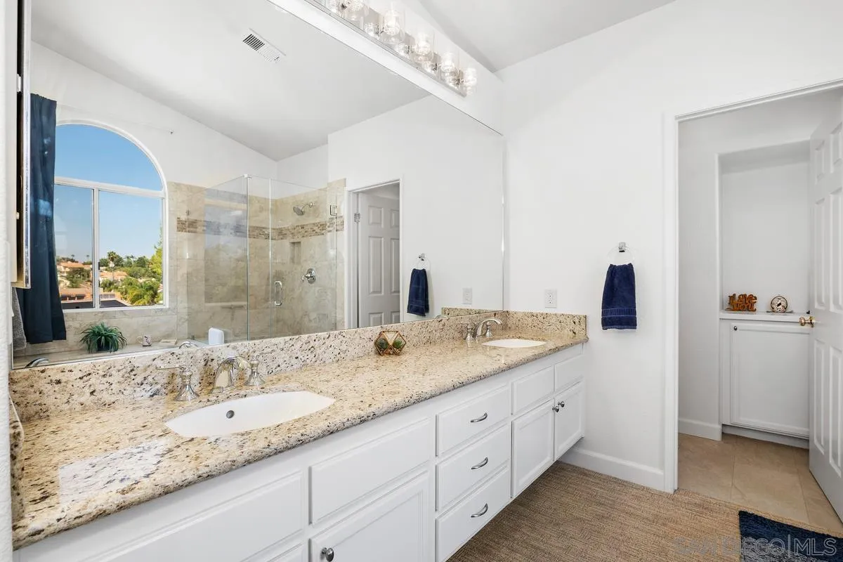 649 Montage Road Oceanside, CA 92057 - Photo 15 of 26 a bathroom with a granite countertop double vanity sink and mirror