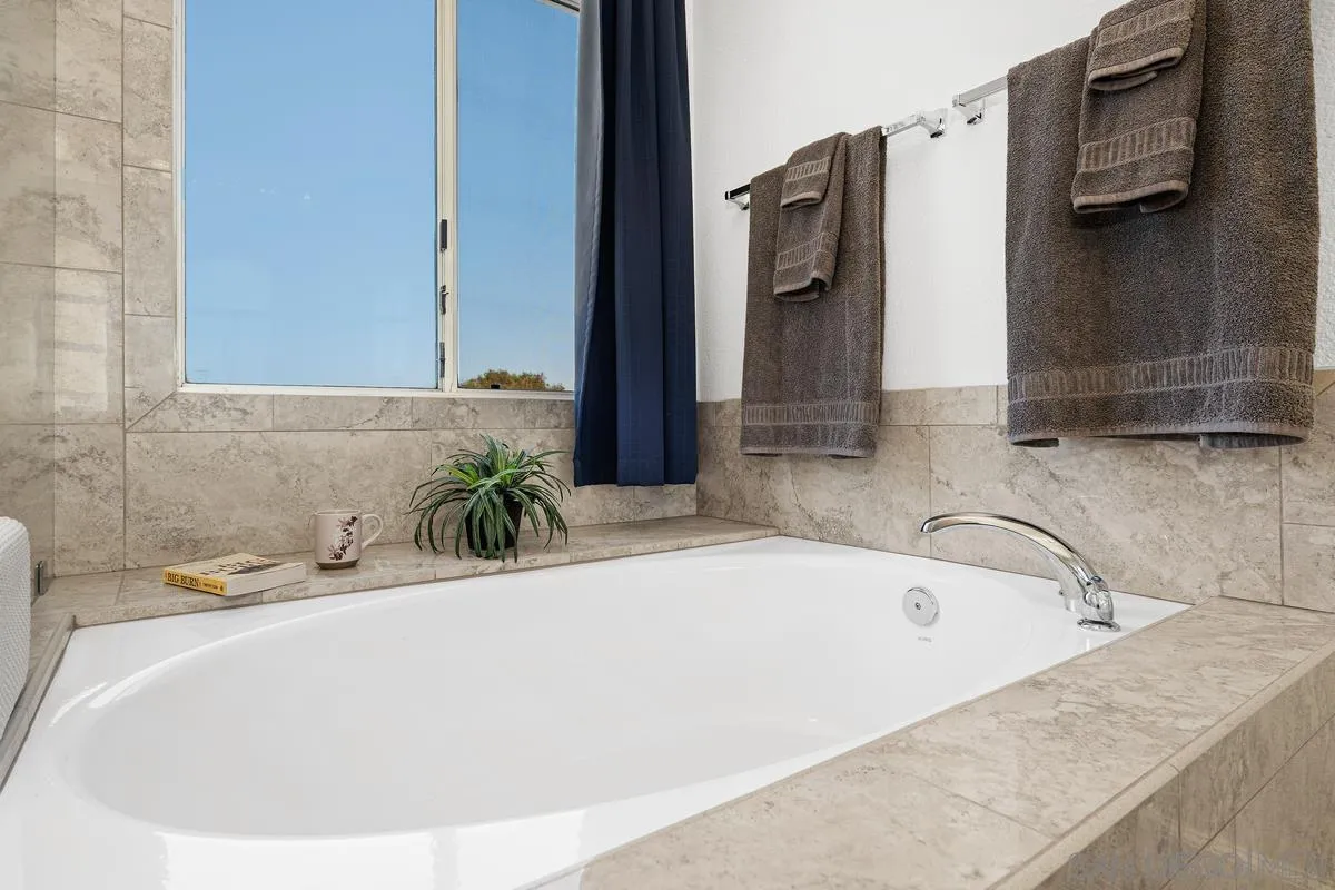 649 Montage Road Oceanside, CA 92057 - Photo 17 of 26 a white bath tub sitting in a bathroom