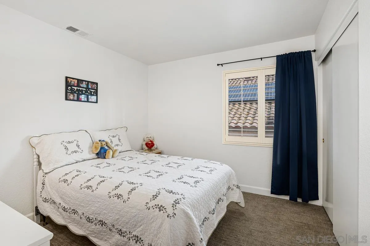 649 Montage Road Oceanside, CA 92057 - Photo 20 of 26 a bedroom with a bed and a window